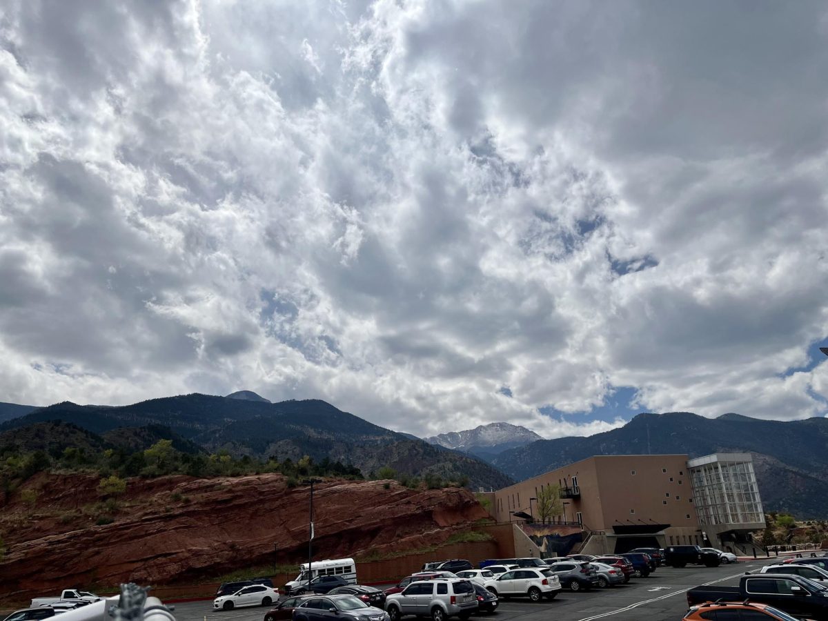 The clouds part over Manitou Springs High School's parking lot after hanging low all day.