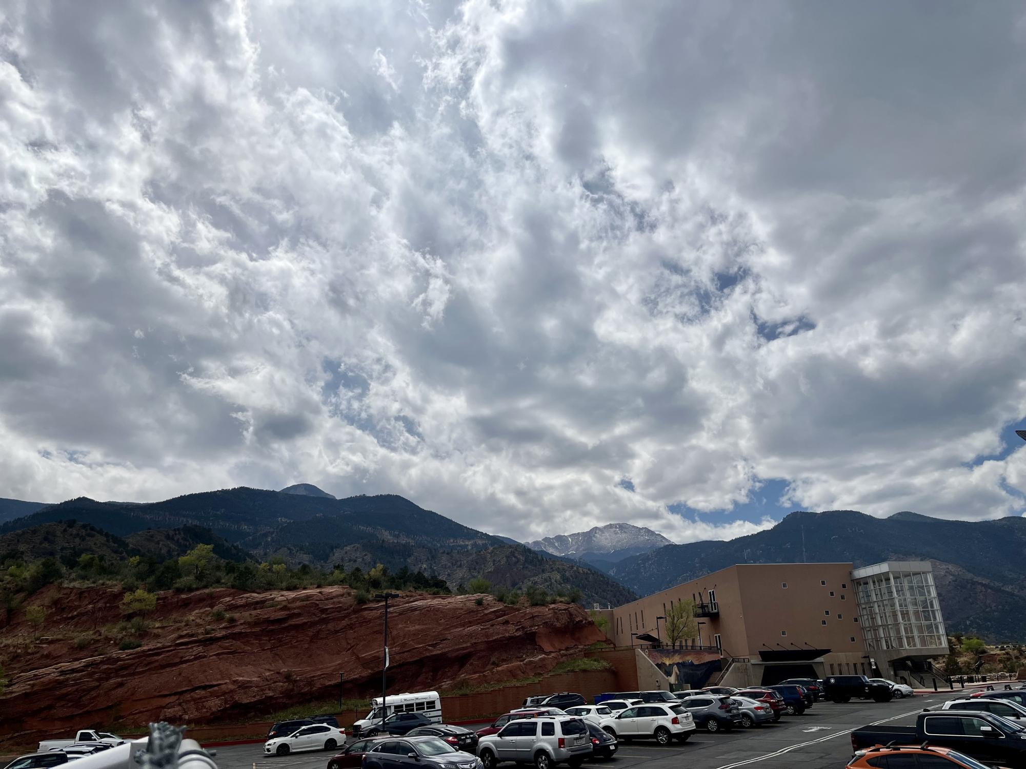 The clouds part over Manitou Springs High School's parking lot after hanging low all day. 